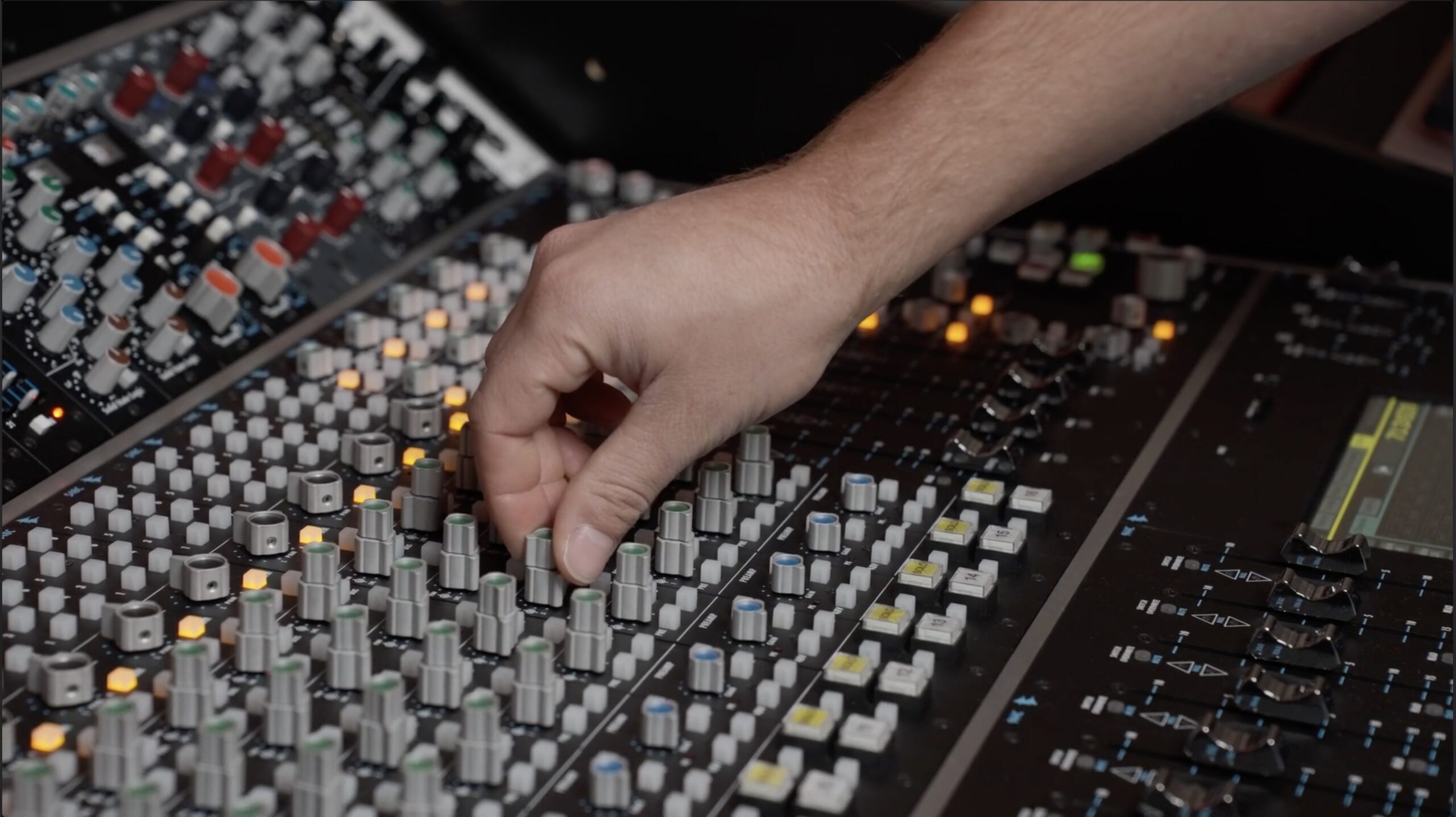 Front-of-house mixing console facing a live performance stage