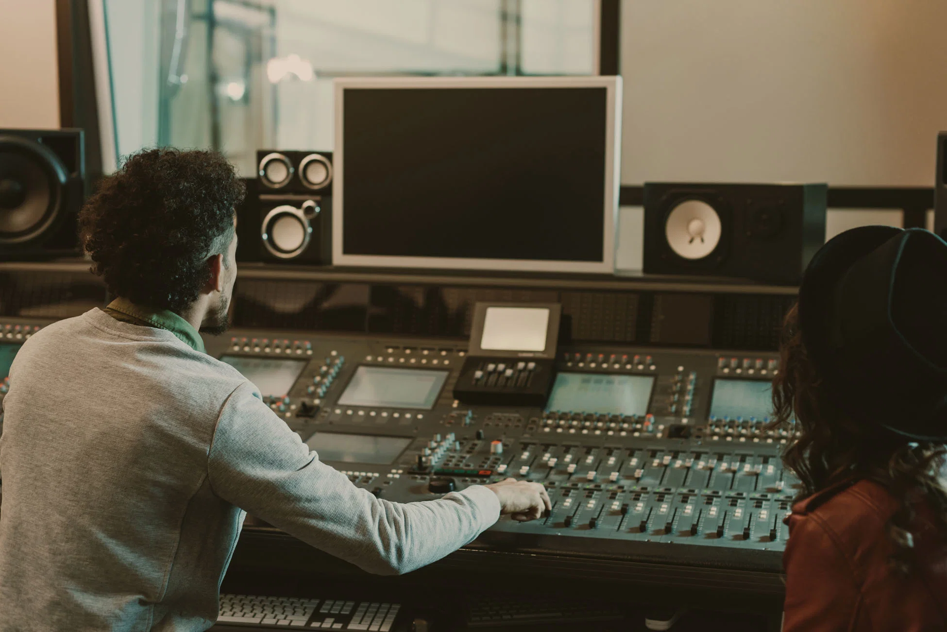 Audio engineer reviewing a recording session at the console