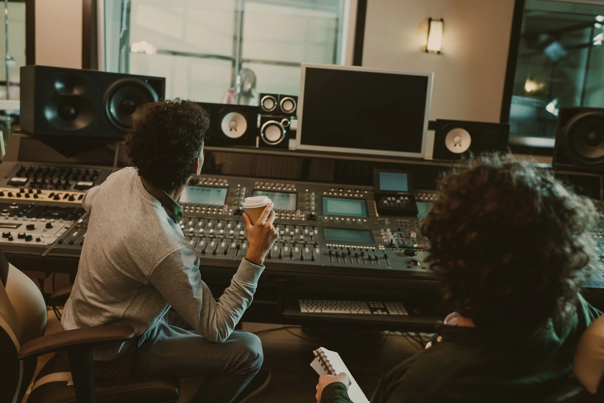 Production team reviewing a session in a recording control room