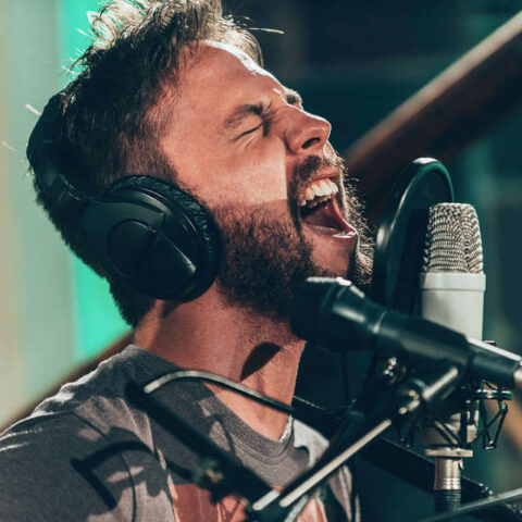 Vocalist tracking at a studio microphone