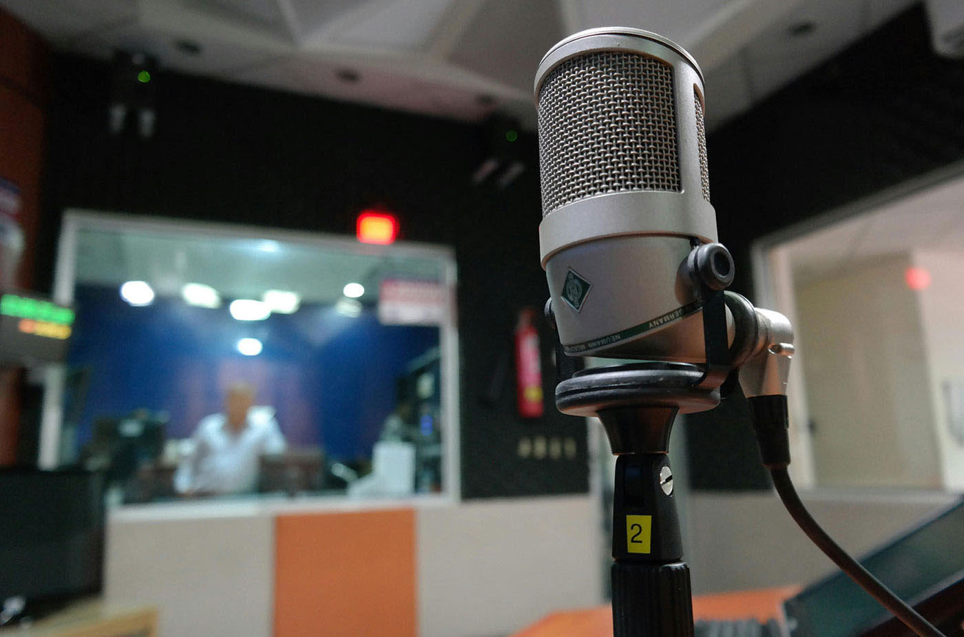 Studio microphone positioned over a recording console